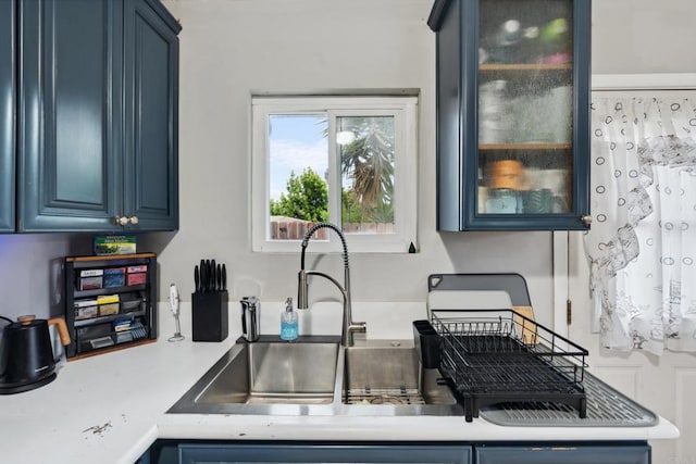 1191 Wren St, San Diego, CA 92114 - kitchen featuring blue cabinets, light countertops, and glass insert cabinets
