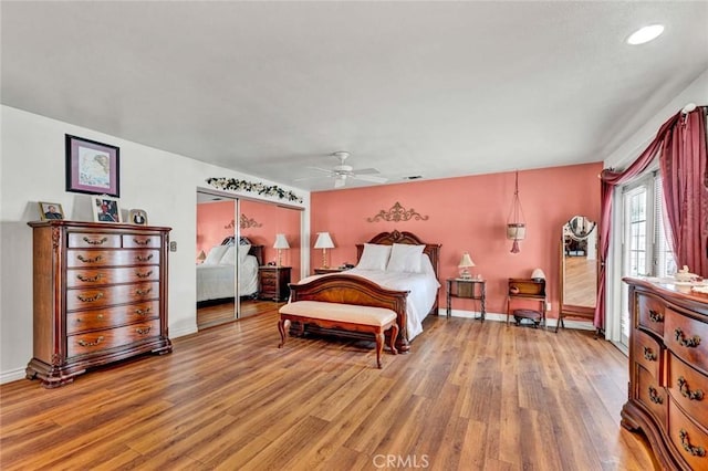 bedroom featuring a closet, baseboards, a ceiling fan, and light wood-type flooring