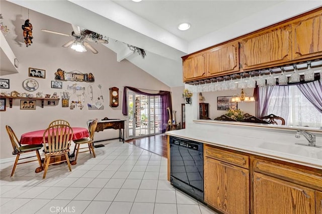 kitchen with brown cabinetry, lofted ceiling, ceiling fan, black dishwasher, and light countertops