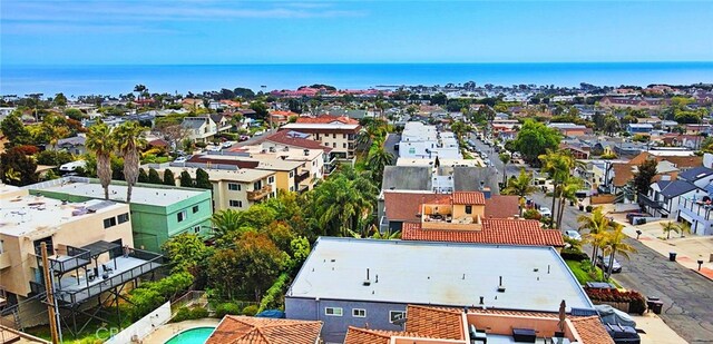 drone / aerial view with a water view and a residential view
