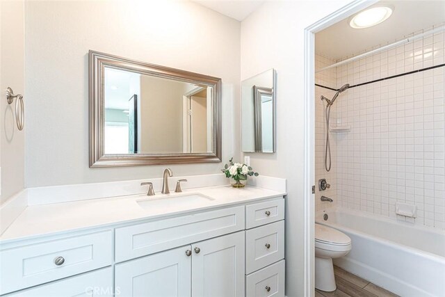 full bathroom featuring vanity, bathtub / shower combination, and toilet