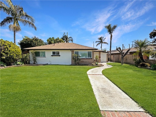 single story home with stucco siding, fence, and a front yard
