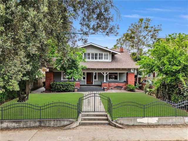 view of front of property with a gate, a chimney, covered porch, a front lawn, and a fenced front yard