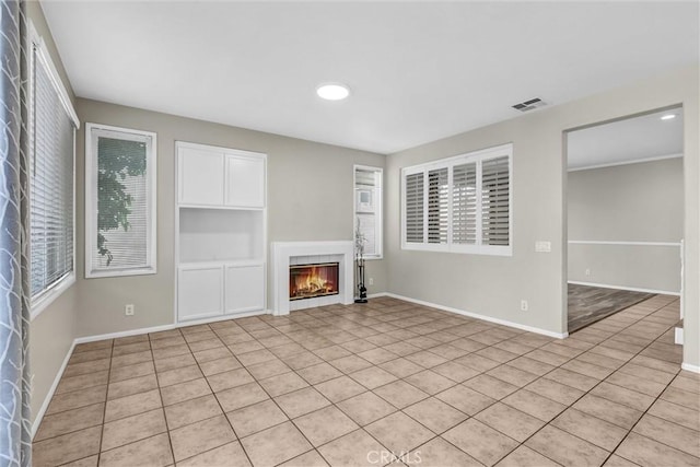 11 Santa Cruz Aisle, Irvine, CA 92606 - unfurnished living room with light tile patterned floors, visible vents, a lit fireplace, and baseboards