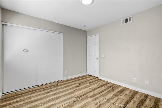 11 Santa Cruz Aisle, Irvine, CA 92606 - unfurnished bedroom with baseboards, visible vents, wood finished floors, and a closet