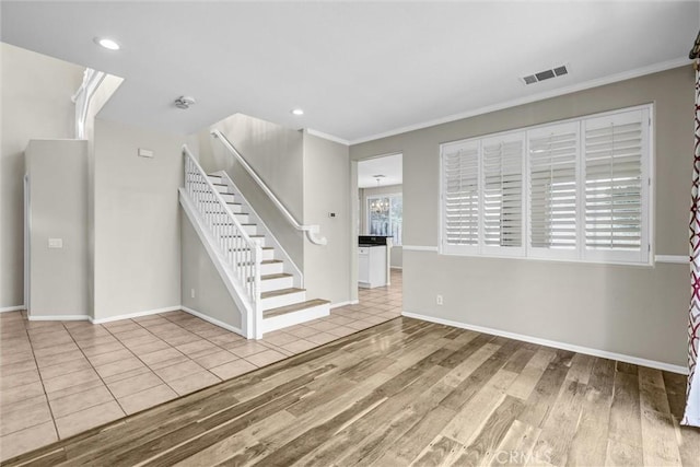 11 Santa Cruz Aisle, Irvine, CA 92606 - unfurnished living room featuring visible vents, stairway, wood finished floors, and crown molding