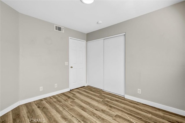 11 Santa Cruz Aisle, Irvine, CA 92606 - unfurnished bedroom with wood finished floors, visible vents, a closet, and baseboards