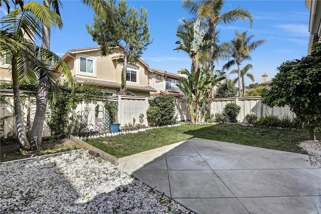 11 Santa Cruz Aisle, Irvine, CA 92606 - back of house featuring a tile roof, a patio, a fenced backyard, a lawn, and stucco siding