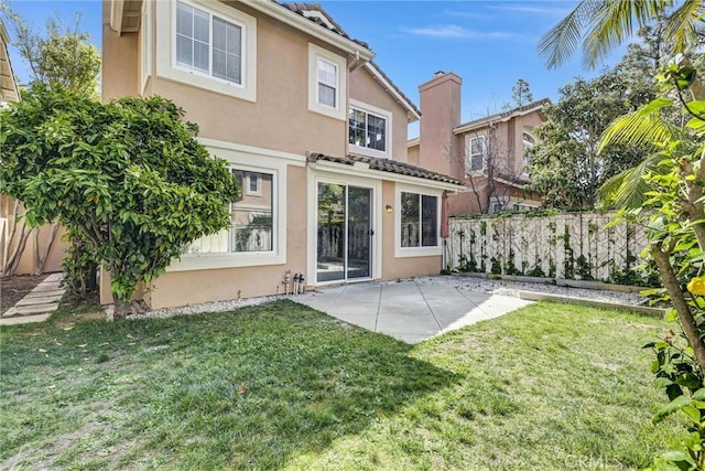 11 Santa Cruz Aisle, Irvine, CA 92606 - rear view of property featuring stucco siding, a patio area, a lawn, and a fenced backyard