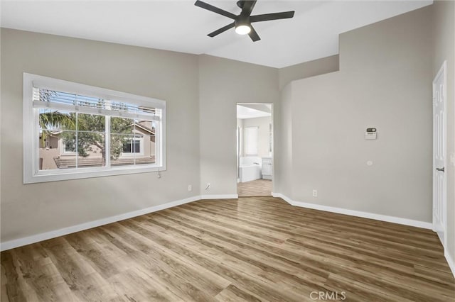11 Santa Cruz Aisle, Irvine, CA 92606 - unfurnished bedroom featuring connected bathroom, ceiling fan, baseboards, vaulted ceiling, and wood finished floors