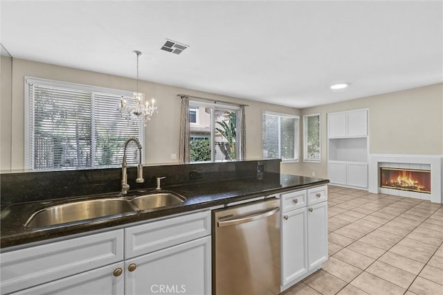 11 Santa Cruz Aisle, Irvine, CA 92606 - kitchen featuring an inviting chandelier, stainless steel dishwasher, light tile patterned floors, white cabinets, and a sink