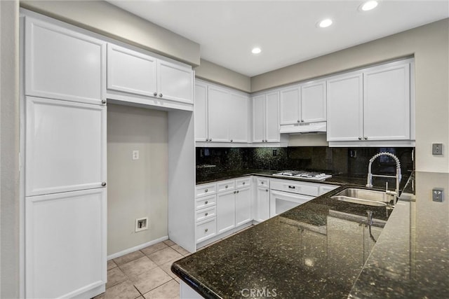 11 Santa Cruz Aisle, Irvine, CA 92606 - kitchen featuring dark stone counters, a sink, white cabinetry, and under cabinet range hood