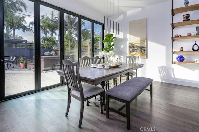 dining space with wood finished floors