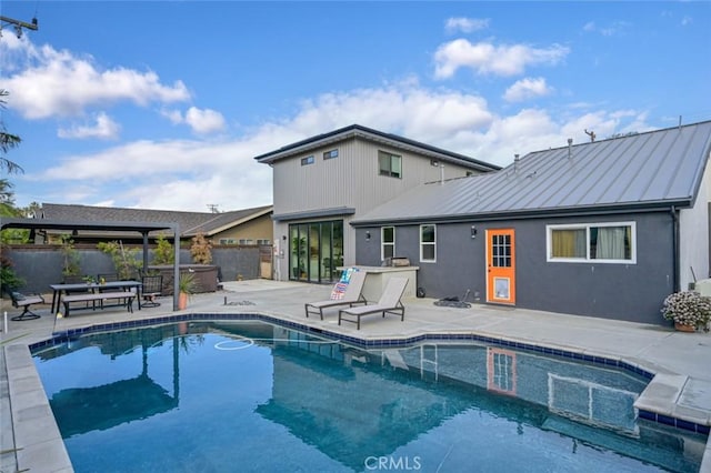 view of pool with fence, a pergola, a patio, a fenced in pool, and a hot tub