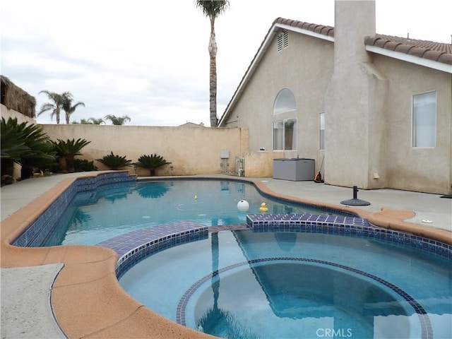 4012 Larkspur Ave, Rialto, CA 92377 - view of pool featuring a pool with connected hot tub and a fenced backyard