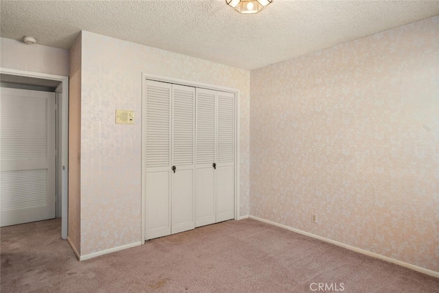 1 Piedmont Cir, Chico, CA 95926 - unfurnished bedroom with carpet, a closet, a textured ceiling, and baseboards