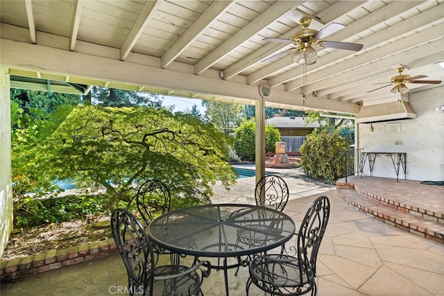 view of patio / terrace with outdoor dining space, an outdoor pool, ceiling fan, and fence