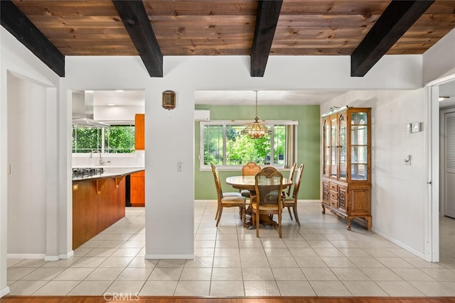 dining room featuring wooden ceiling, light tile patterned floors, and baseboards