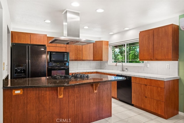 kitchen with backsplash, black appliances, a sink, and island range hood