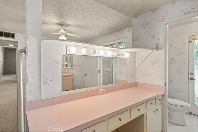 bathroom with a textured ceiling, vanity, visible vents, and wallpapered walls