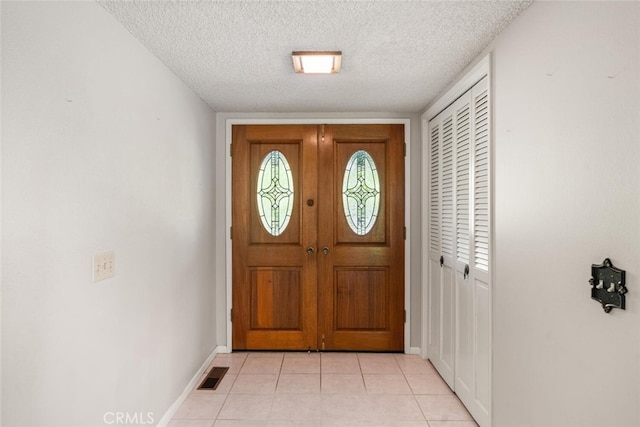 1 Piedmont Cir, Chico, CA 95926 - doorway to outside with a textured ceiling, baseboards, and light tile patterned floors