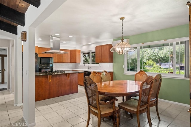 dining space with light tile patterned floors, a chandelier, baseboards, and recessed lighting