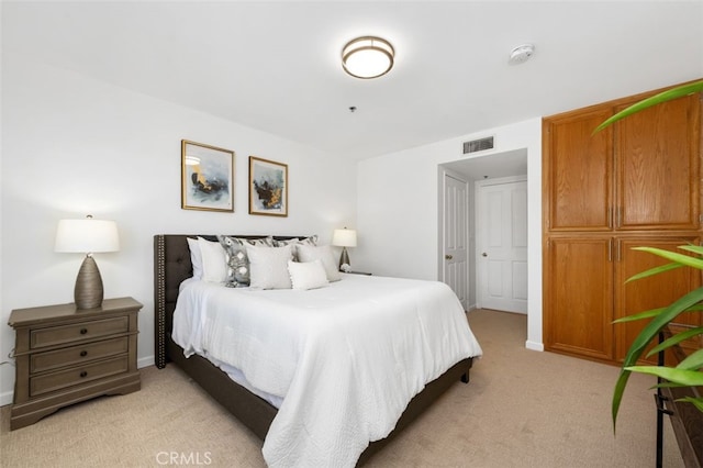 bedroom featuring light colored carpet and baseboards