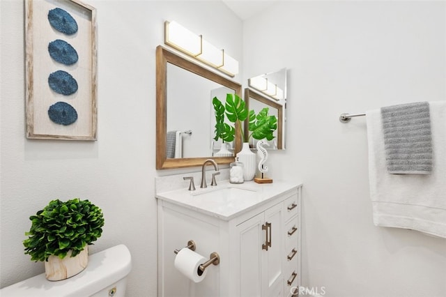 half bathroom with toilet and vanity