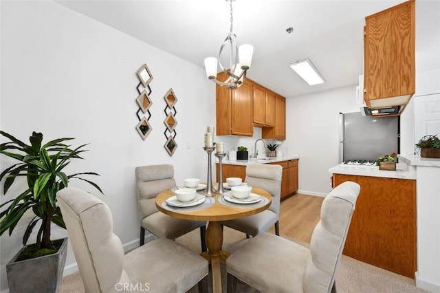 dining space with light wood-style flooring and baseboards
