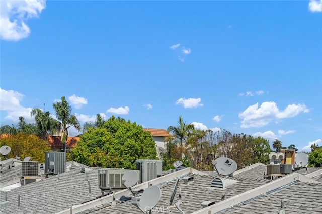 exterior view of a shingled roof, a satellite dish, and central air condition unit