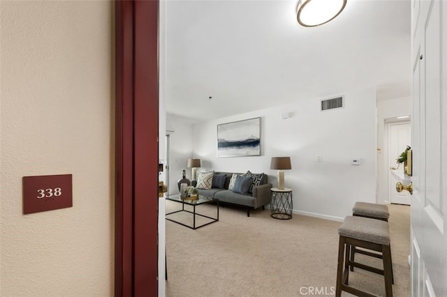 carpeted living room with baseboards