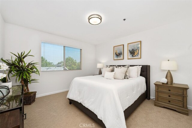 carpeted bedroom featuring baseboards
