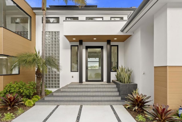 doorway to property with stucco siding