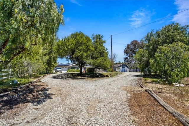 view of road featuring gravel driveway