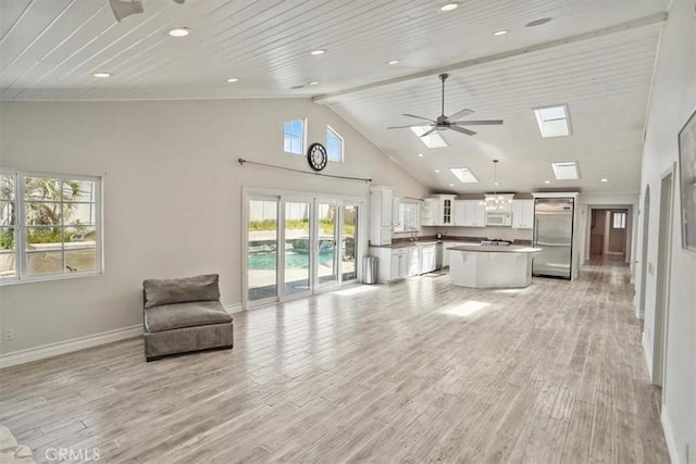 living room with ceiling fan, high vaulted ceiling, baseboards, light wood-style floors, and recessed lighting