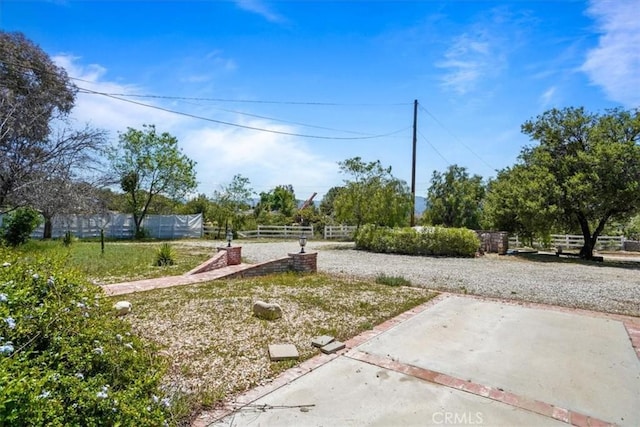 view of yard with a patio and fence