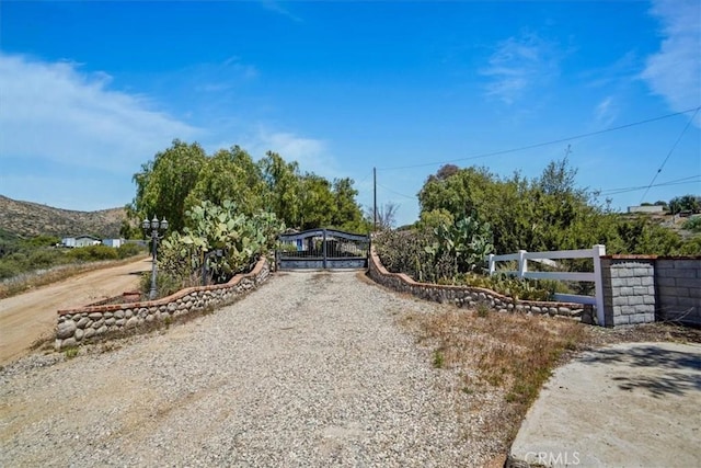view of street with gravel driveway