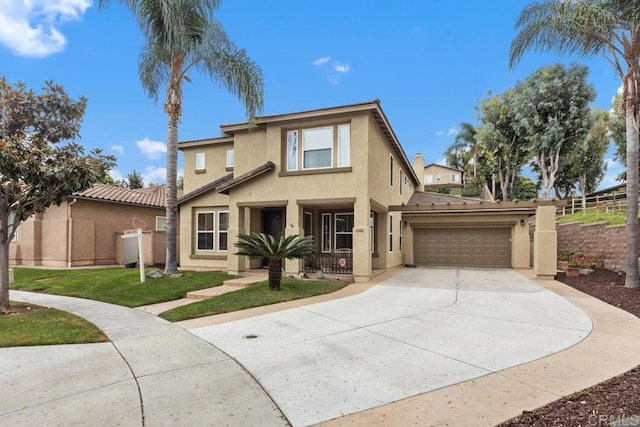 view of front of house with fence, stucco siding, driveway, and an attached garage