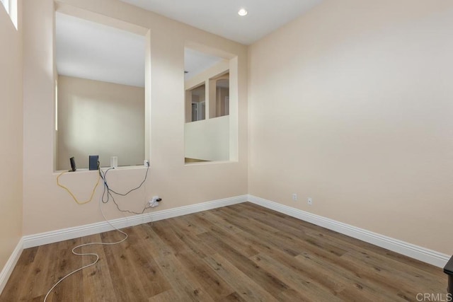 interior space with baseboards, recessed lighting, and wood finished floors