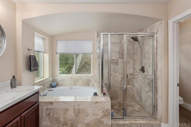 full bath featuring toilet, a bath, vanity, a stall shower, and lofted ceiling