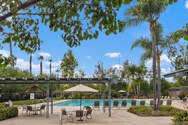 pool with fence and a patio area
