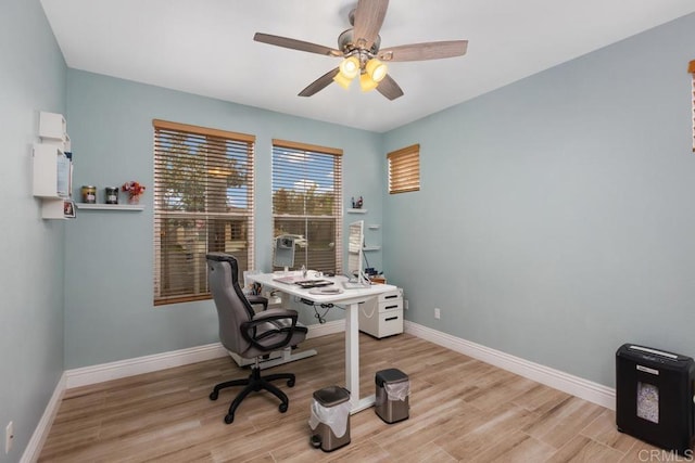 office area featuring wood finished floors, ceiling fan, and baseboards