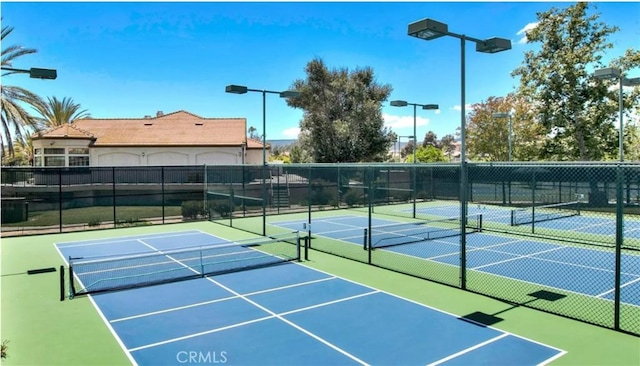 view of tennis court with fence