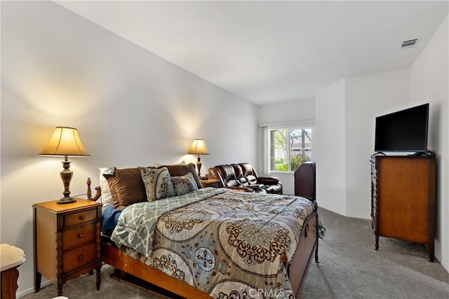 carpeted bedroom featuring visible vents