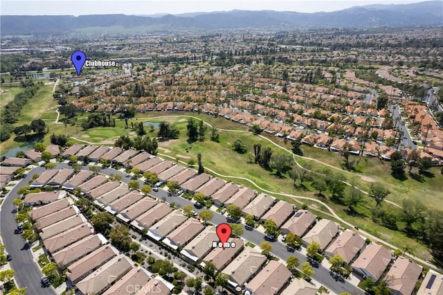 birds eye view of property with a residential view, a mountain view, and view of golf course