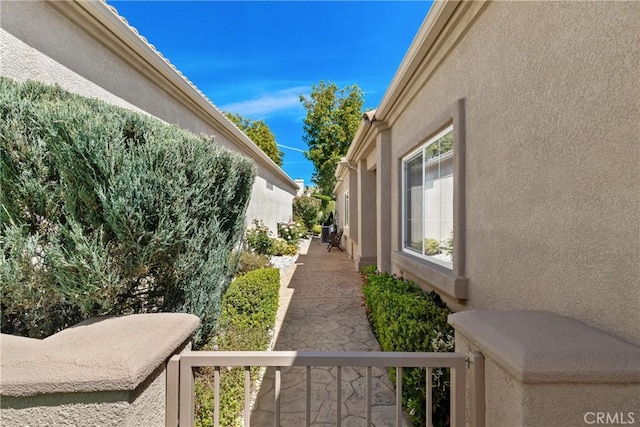 exterior space with a balcony and stucco siding