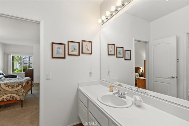 ensuite bathroom featuring vanity and connected bathroom