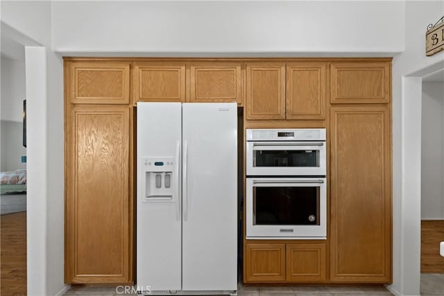 kitchen with white appliances and baseboards