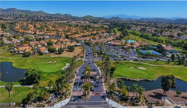 aerial view featuring a water and mountain view, golf course view, and a residential view