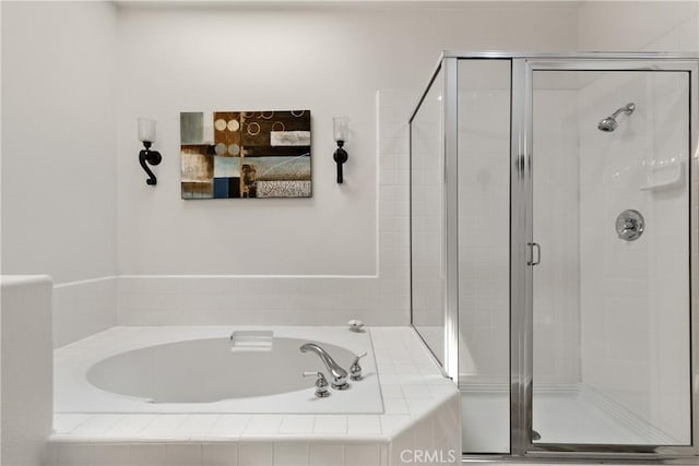 full bath with a bath and a stall shower